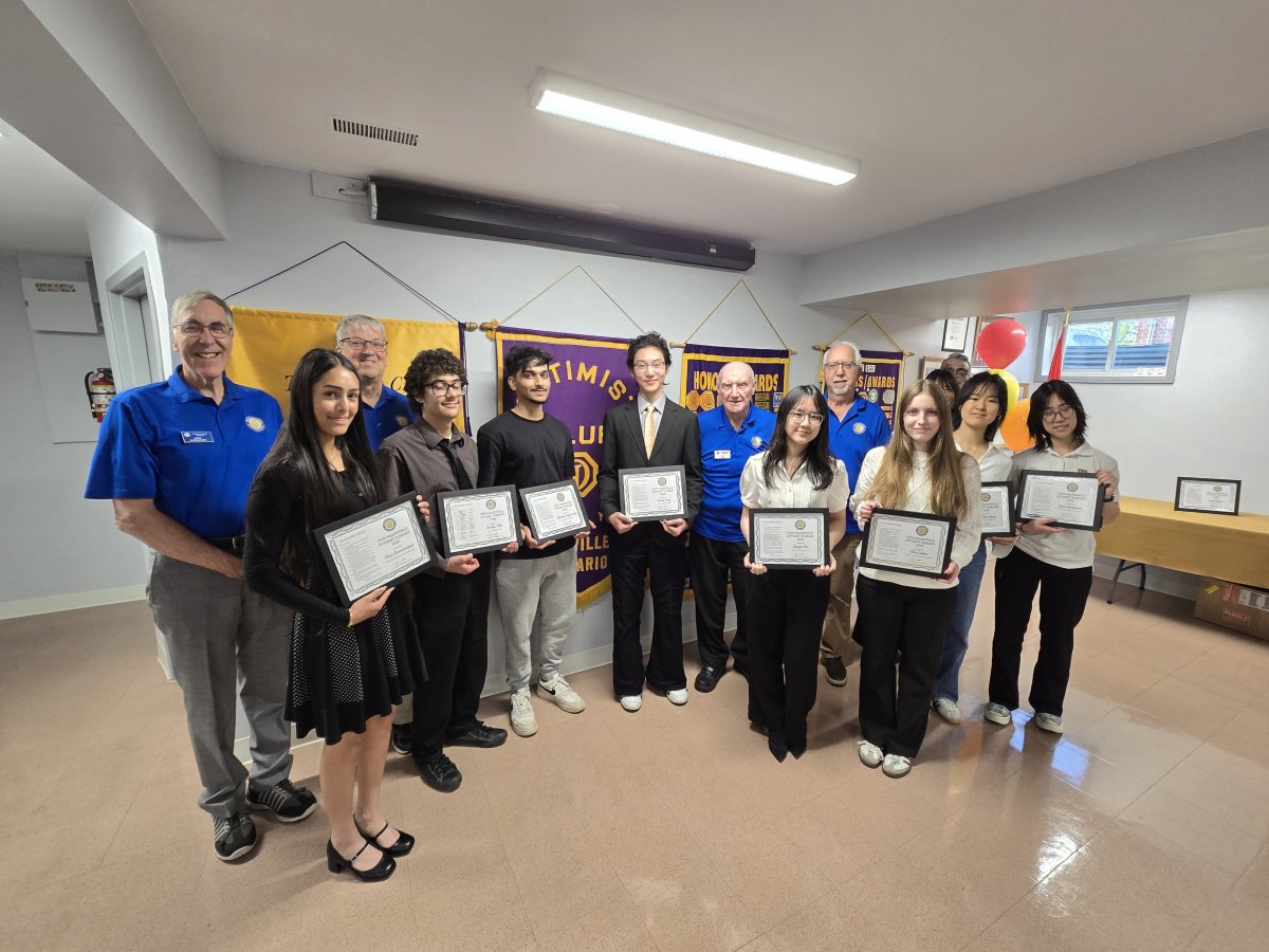 A small group of Bursary Winners, with the Chair of the Committee